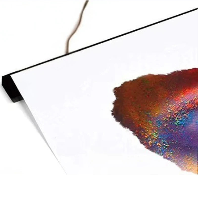 Colorful powder on a white background with a black border