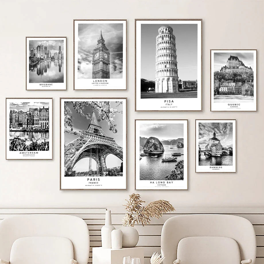 Set of black and white cityscape prints on a wall above a sofa.