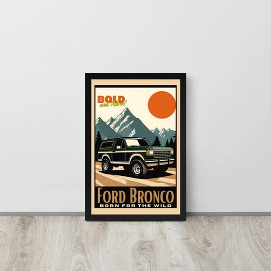 Framed poster of a Ford Bronco with mountain and sun design on a white wall. Canvas & Curio