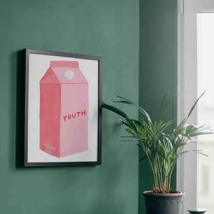 Framed artwork of a pink milk carton with 'TRUTH' on a green wall, next to a potted plant.