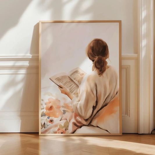 Framed artwork of a woman reading a book with flowers in a softly lit room. Canvas & Curio