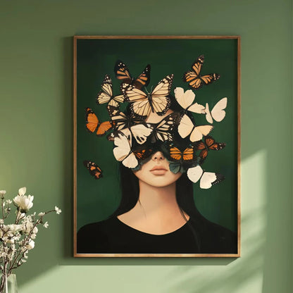 Framed artwork of a woman's face with butterflies on a green wall.