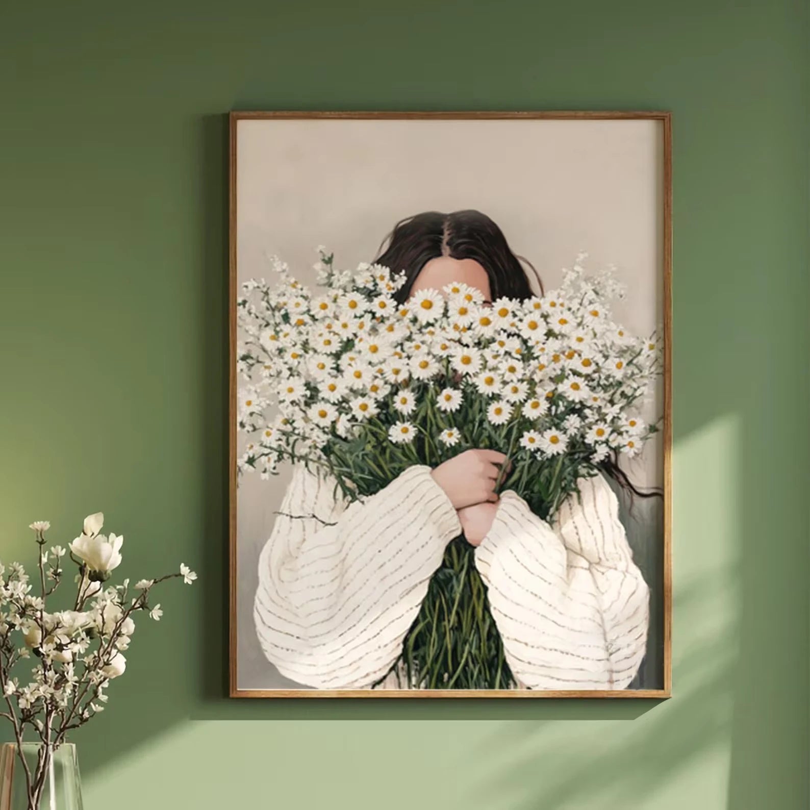 Framed artwork of a person holding flowers against a green wall