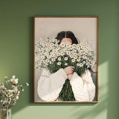 Framed artwork of a person holding flowers against a green wall