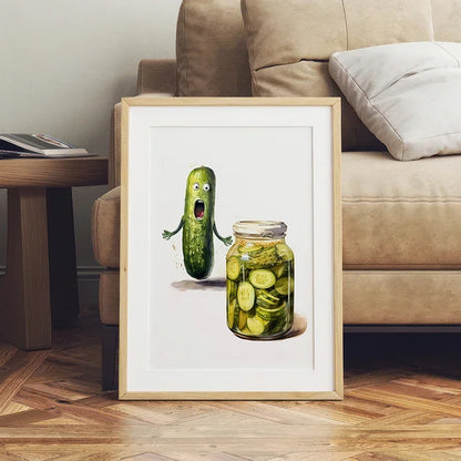 Framed artwork of a pickle and jar on a wooden floor with a couch in the background