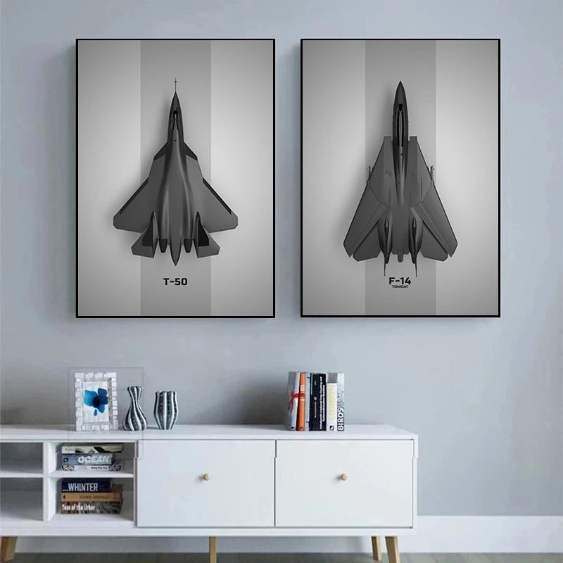 Two framed black fighter jet prints on a gray wall above a white cabinet.