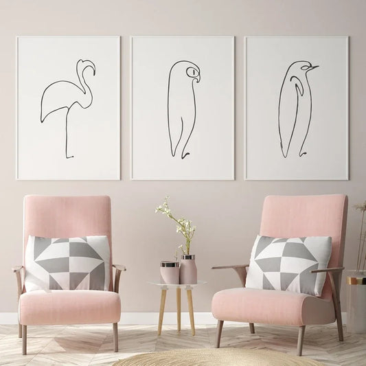 Two pink armchairs with geometric cushions in a room with wall art of line drawings. Canvas & Curio
