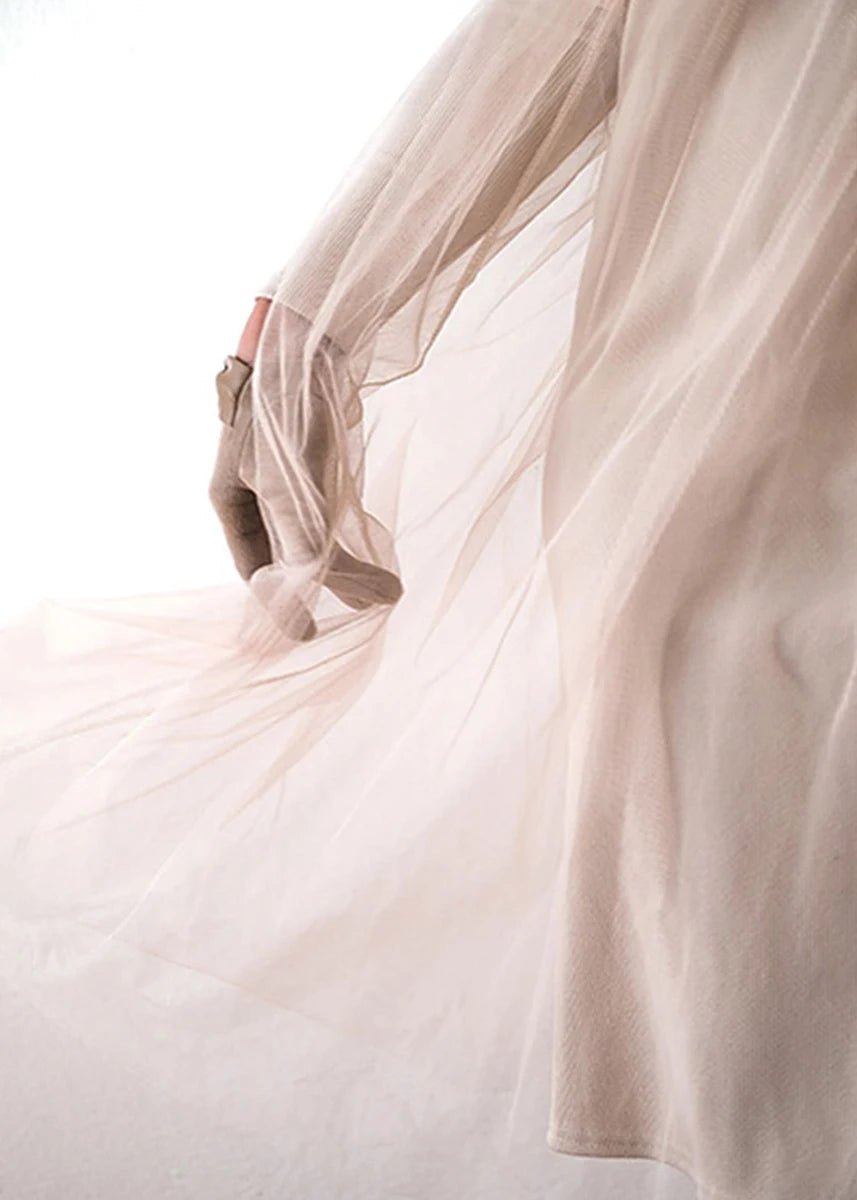 Close-up of a light pink fabric with a soft focus background
