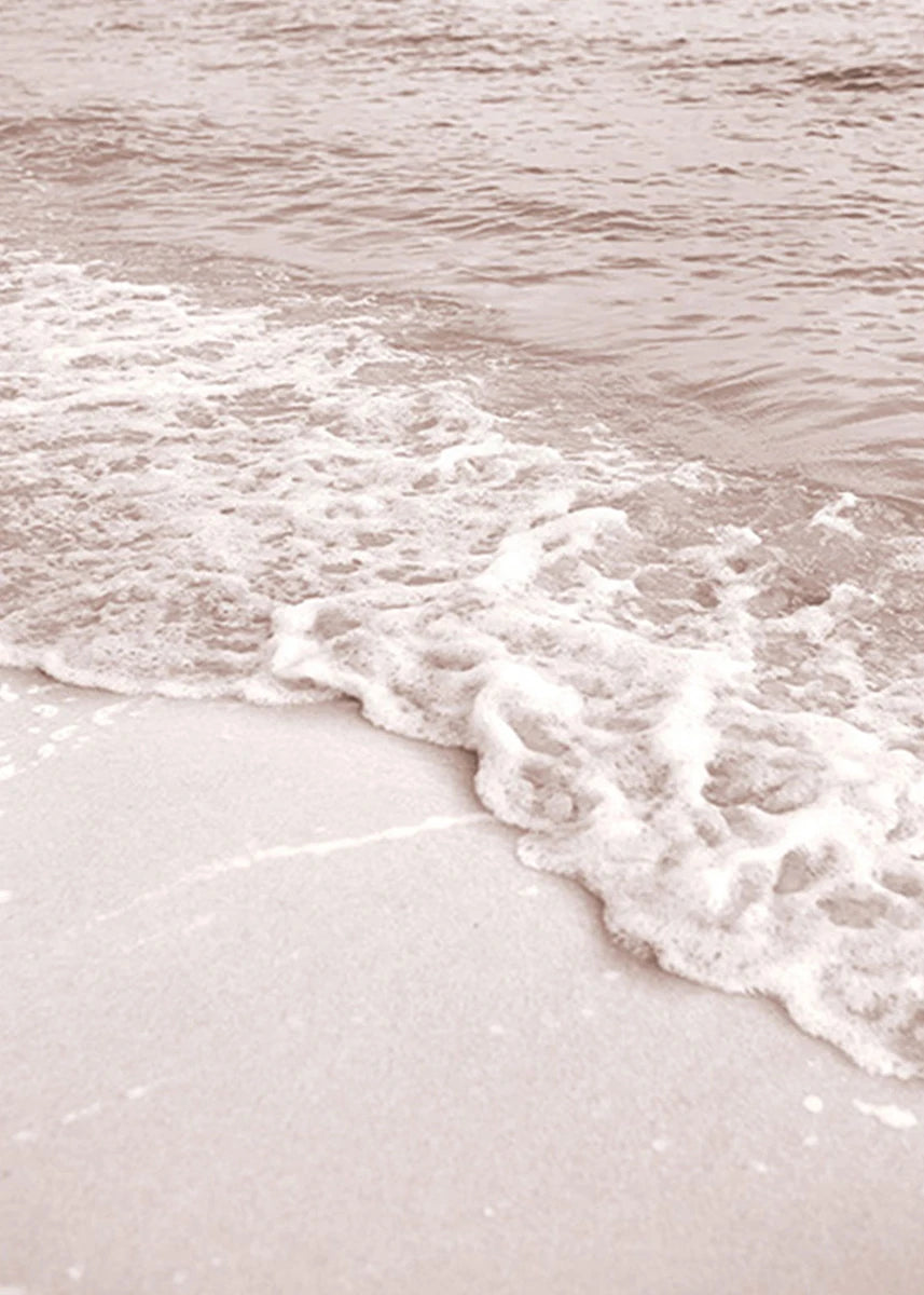Close-up of waves crashing onto a sandy beach