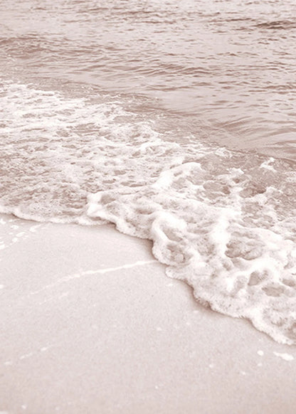 Close-up of waves crashing onto a sandy beach