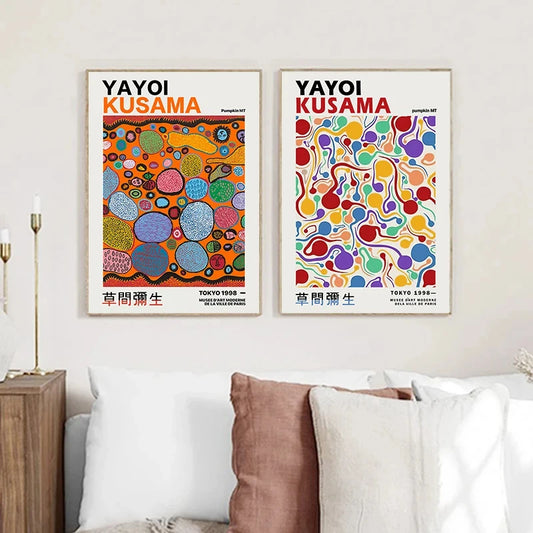 Two colorful Yayoi Kusama art prints on a wall above a sofa. Canvas & Curio