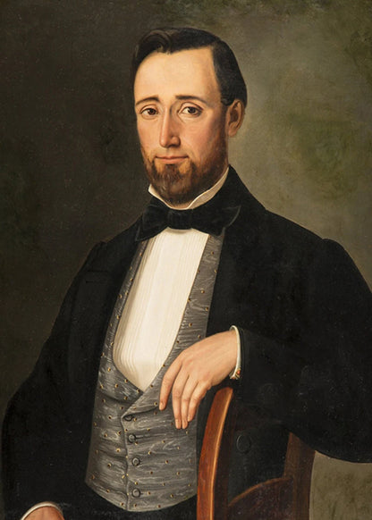 Portrait of a man in formal attire with a dark background
