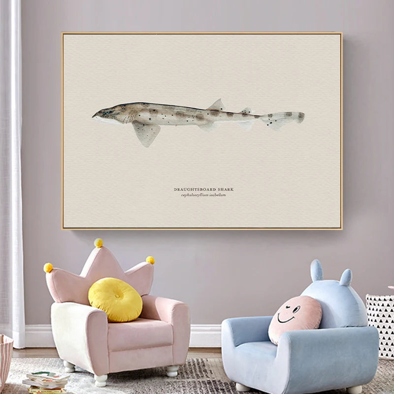 Framed artwork of a shark on a wall above two children's chairs with colorful cushions.