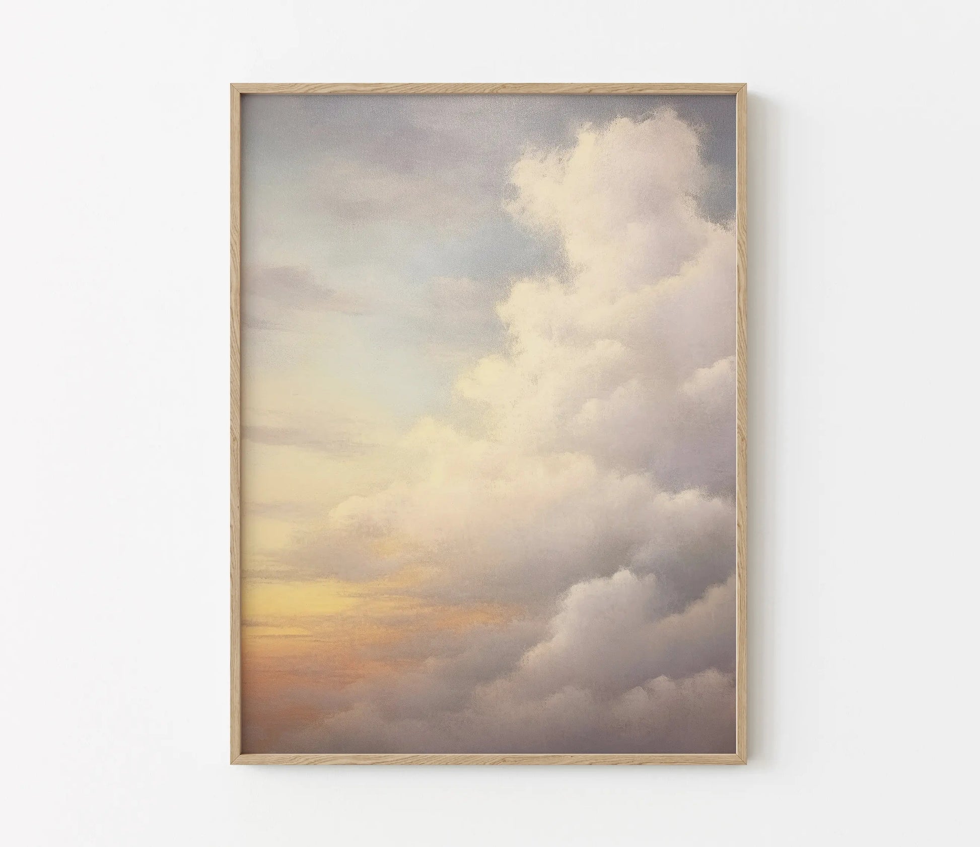 Framed artwork of a cloud scene with a warm color palette on a white wall.
