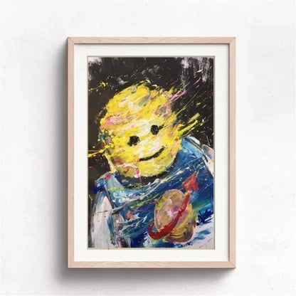 Framed abstract painting of a character with a yellow head and blue outfit on a white wall.