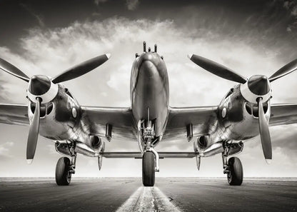 Vintage airplane with propellers on a runway against a cloudy sky
