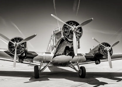 Vintage airplane with three propellers on a runway