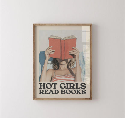 Framed artwork of a woman reading a book with 'Hot Girls Read Books' text on a white wall.