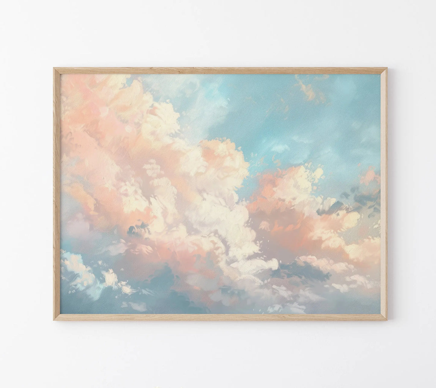 Framed artwork of a sky with clouds on a white wall