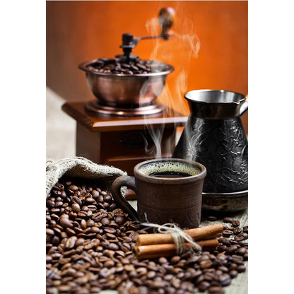 Coffee beans, grinder, and cup with steam on a warm background