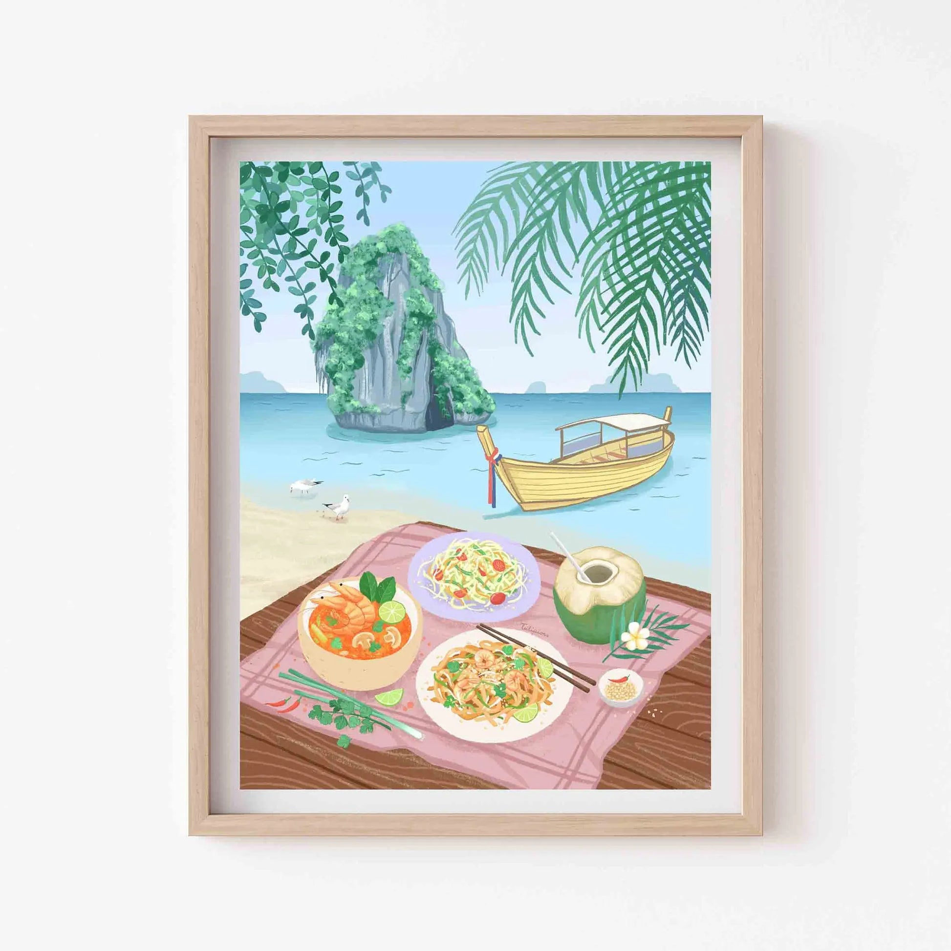 Framed artwork of a tropical beach scene with food on a table.