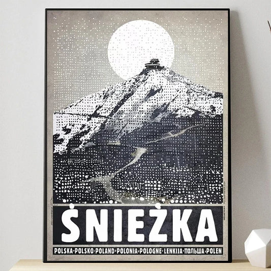 Framed poster of a mountain with 'Sniezka' at the bottom on a light gray wall. Canvas & Curio
