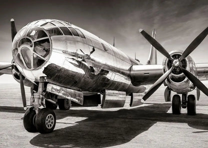 Vintage airplane on a runway with a dramatic sky.