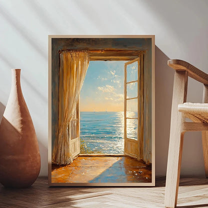 Framed artwork of an open door leading to a beach scene, placed on a wooden floor with a vase and chair.