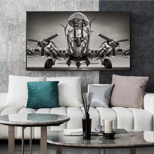 Canvas print of a vintage airplane on a wall above a white sofa with decorative pillows. Canvas & Curio