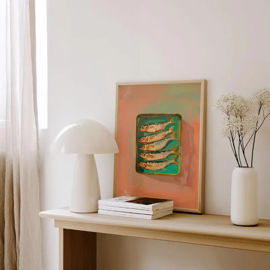 Decorative shelf with a lamp, books, and a vase against a white wall. Canvas & Curio