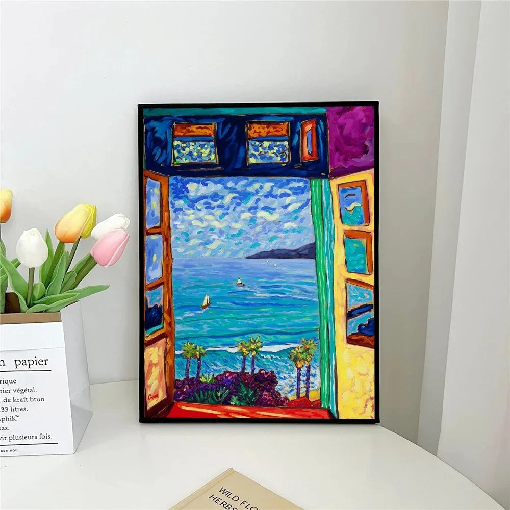 Framed artwork of a colorful window view with sea and sky, placed on a white surface.