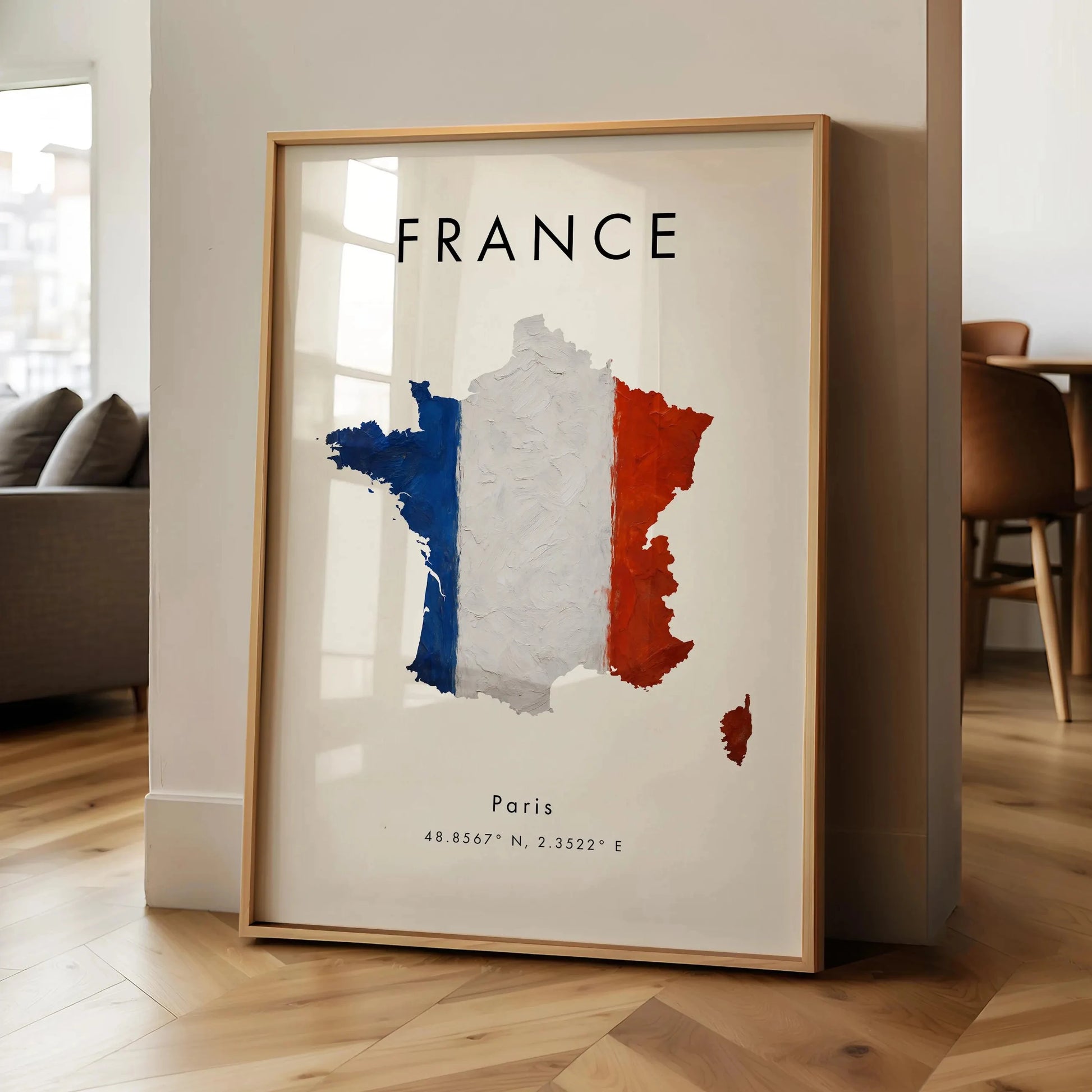 Framed map of France with Paris labeled, leaning against a wall in a room.