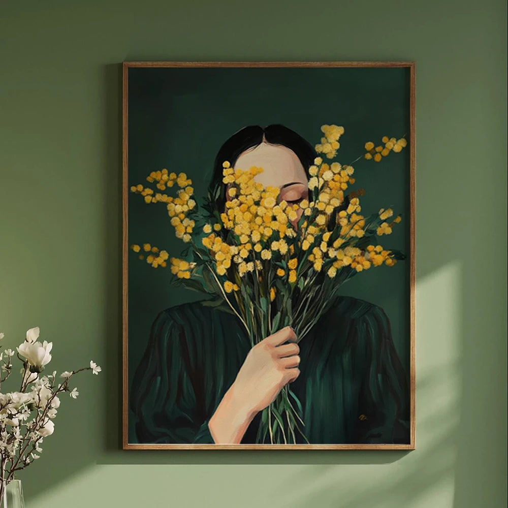 Framed artwork of a person holding yellow flowers against a green wall.