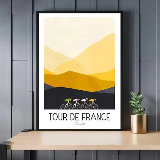 Framed 'Tour de France' poster with cyclists and mountain design on a wooden shelf. Canvas & Curio