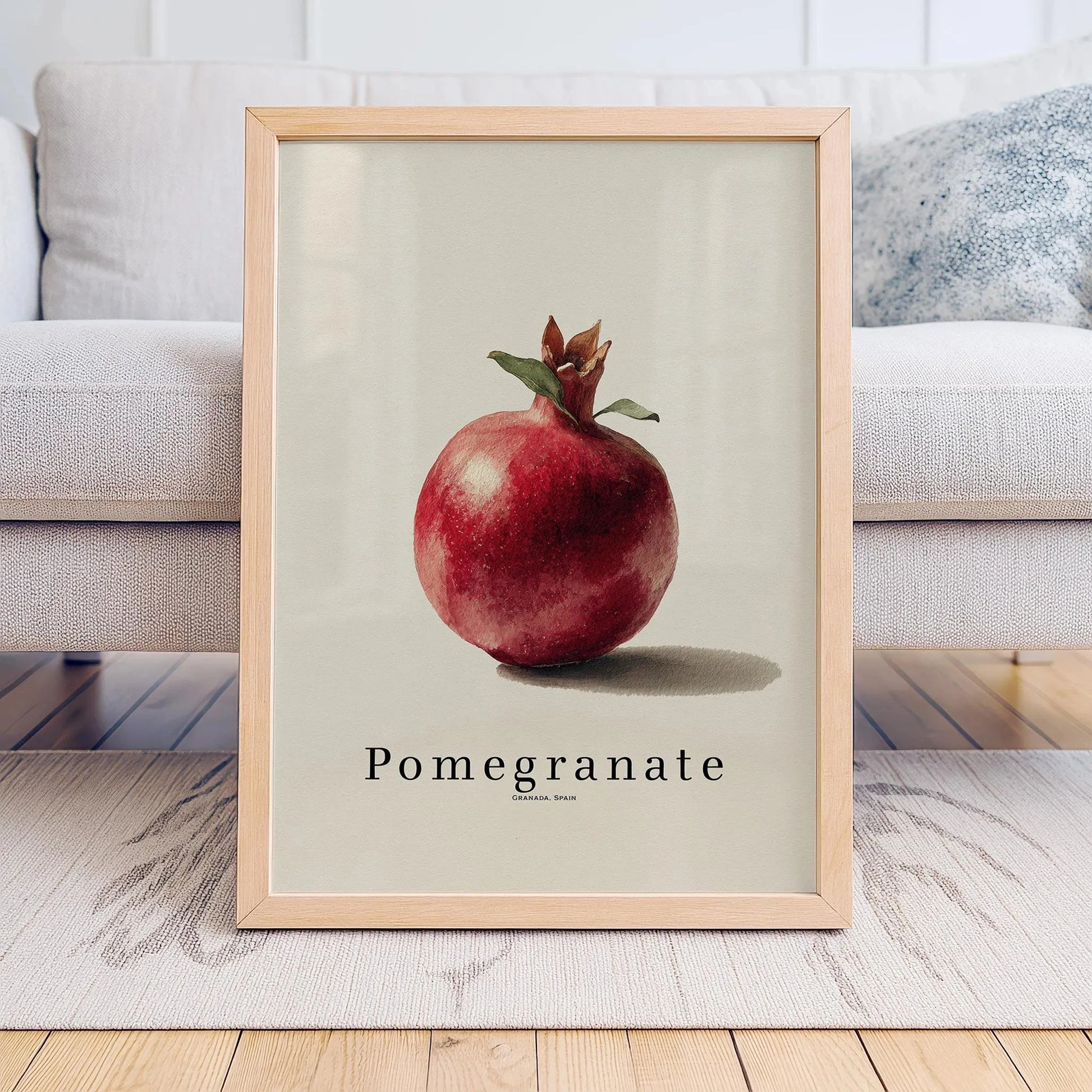 Framed artwork of a pomegranate on a neutral background