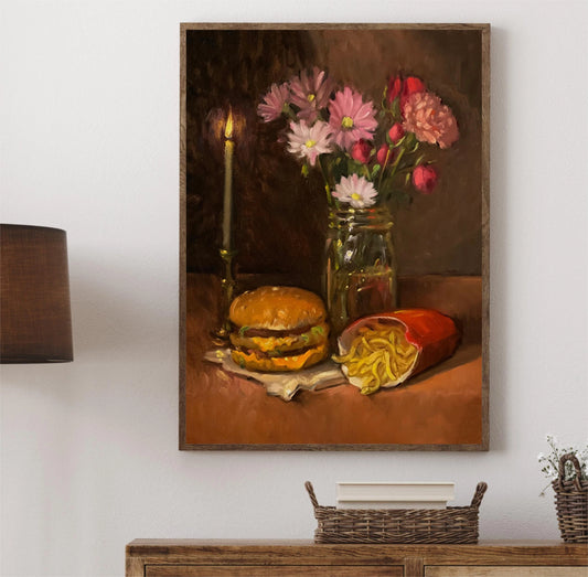 Framed still life painting of a hamburger, fries, and flowers on a wall above a wooden console table. Canvas & Curio