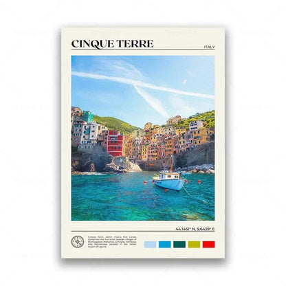 Framed artwork of Cinque Terre with a boat in the water and colorful buildings.