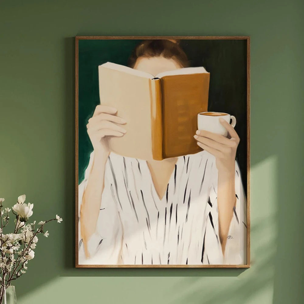 Framed artwork of a person holding a book and a cup against a green wall.
