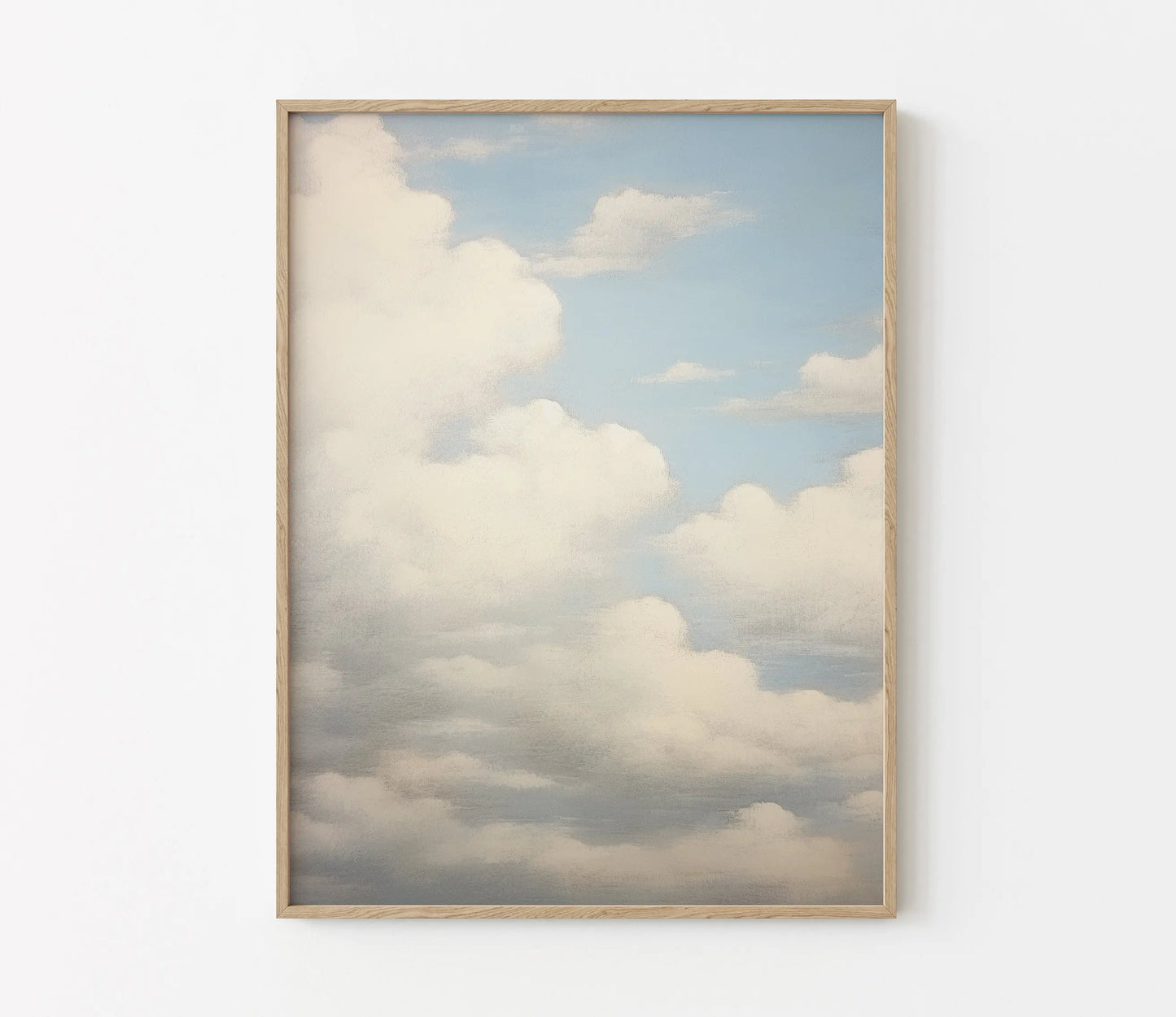 Framed artwork of a cloudy sky on a white wall