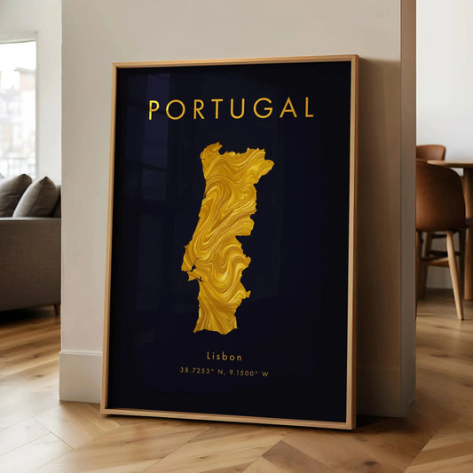 Framed map of Portugal with gold color on a dark background, leaning against a wall in a room. Canvas & Curio