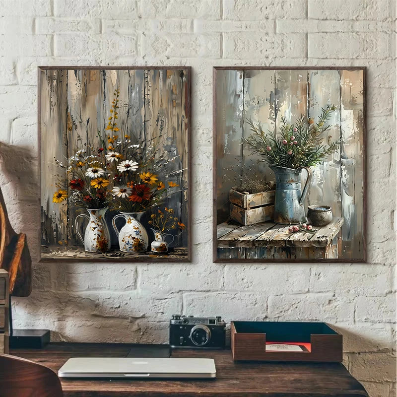 Two framed paintings of floral arrangements on a white brick wall.