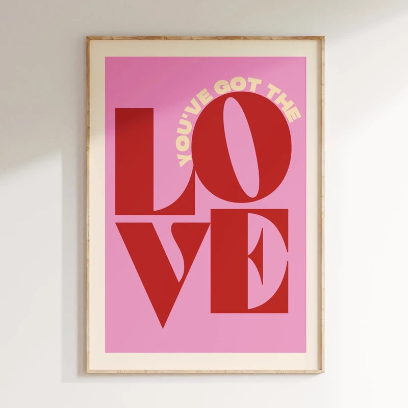 Framed artwork with 'LOVE' in red and 'YOU'VE GOT THE' in yellow on a pink background