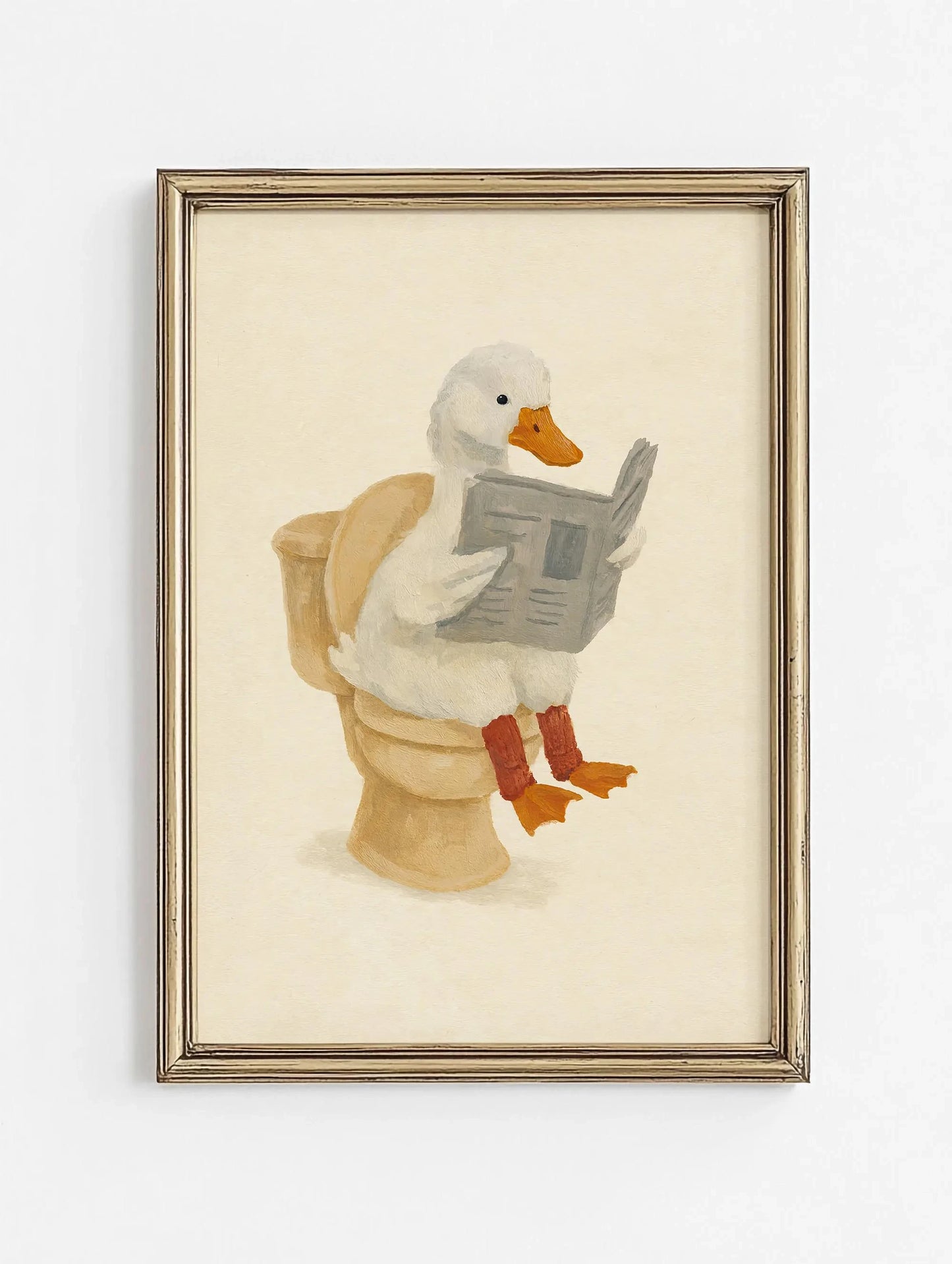 Framed artwork of a goose reading a newspaper on a toilet.