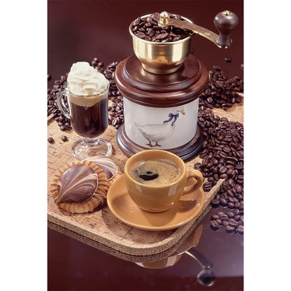 Coffee grinder with a cup of coffee, glass of espresso, and cookies on a surface with coffee beans.