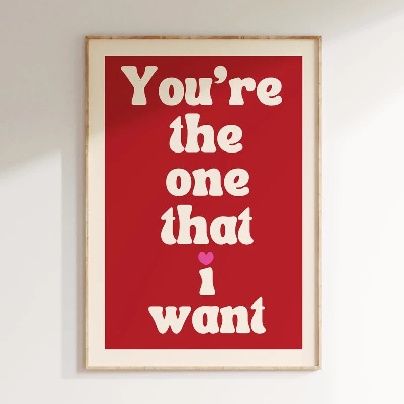 Framed poster with text 'You're the one that I want' on a red background