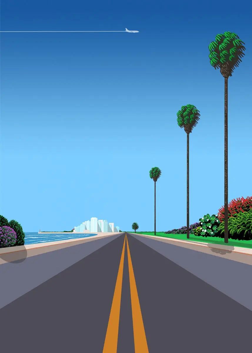 Road leading to a beach with palm trees and a clear blue sky.