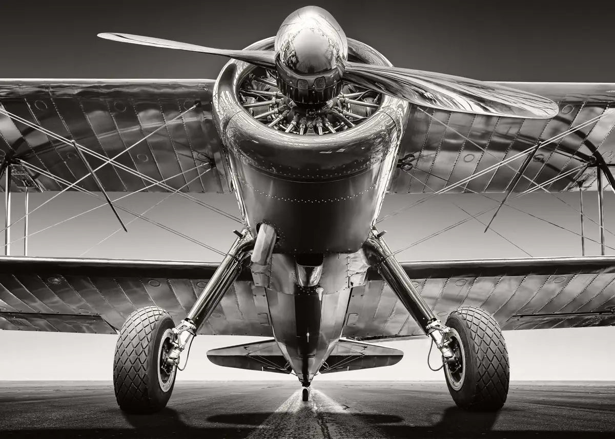 Black and white image of a vintage airplane with a propeller.