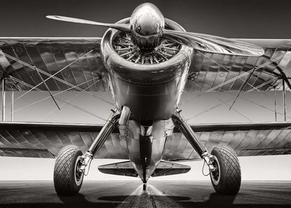 Black and white image of a vintage airplane with a propeller.