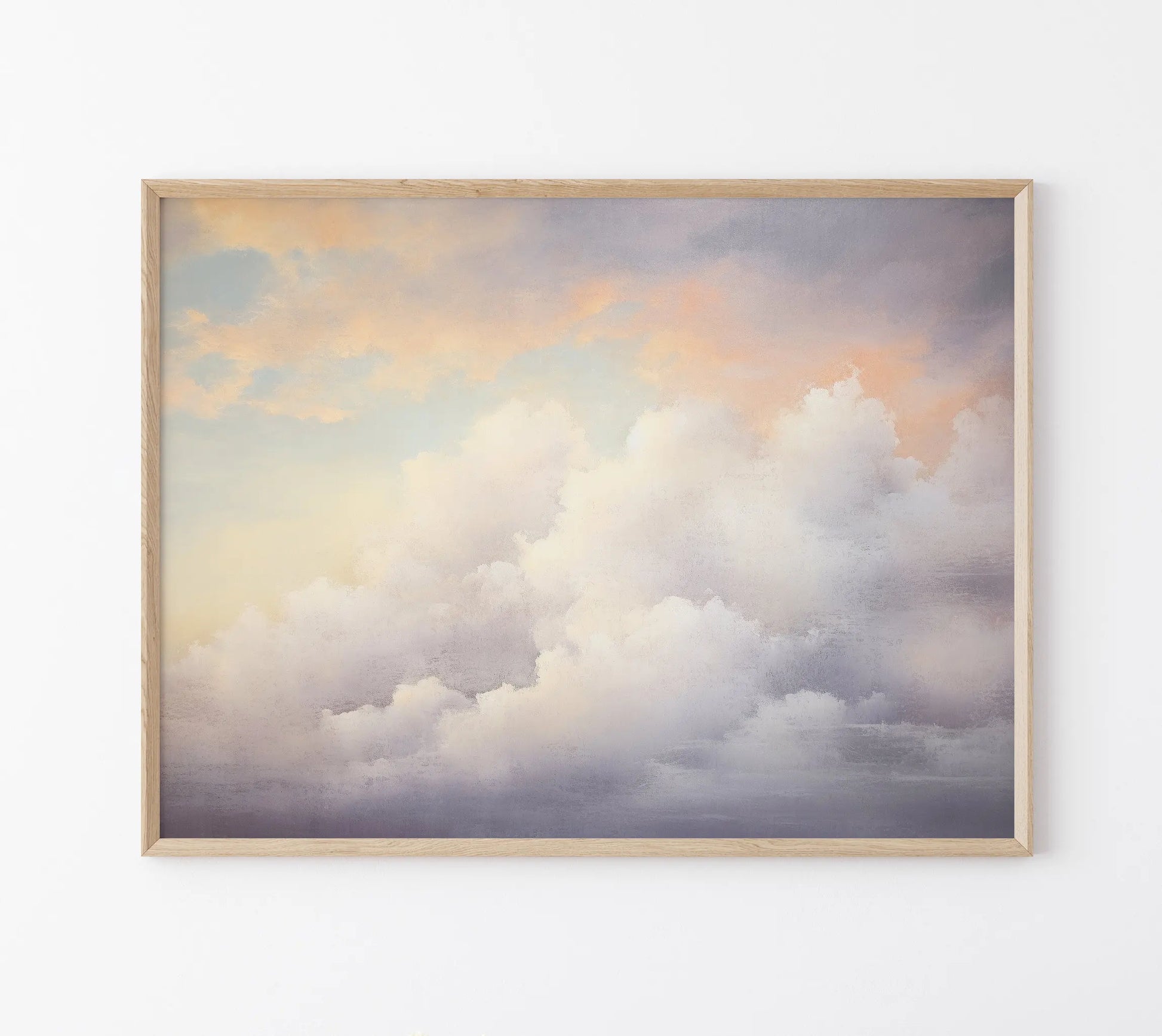 Framed artwork of a cloud scene with a wooden frame on a white wall