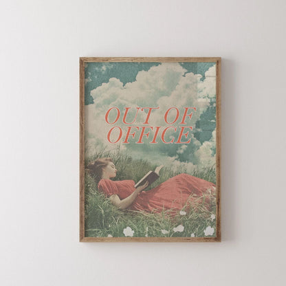 Framed artwork with a woman lying in grass reading a book, titled 'Out of Office'.